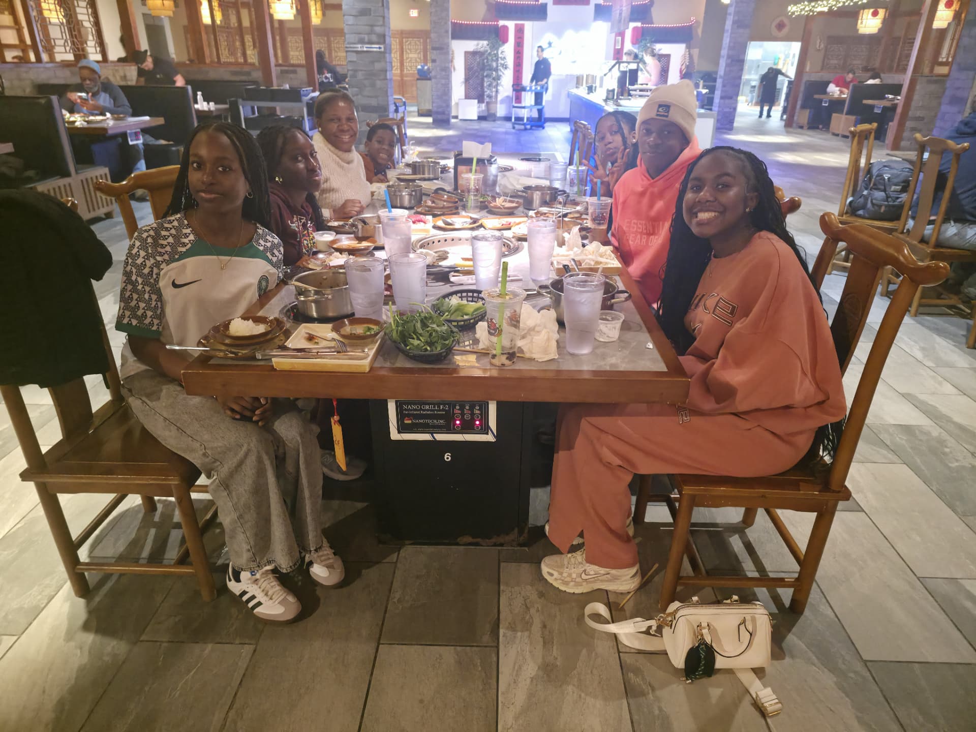 NEXT Academy teens sharing a meal together at a restaurant